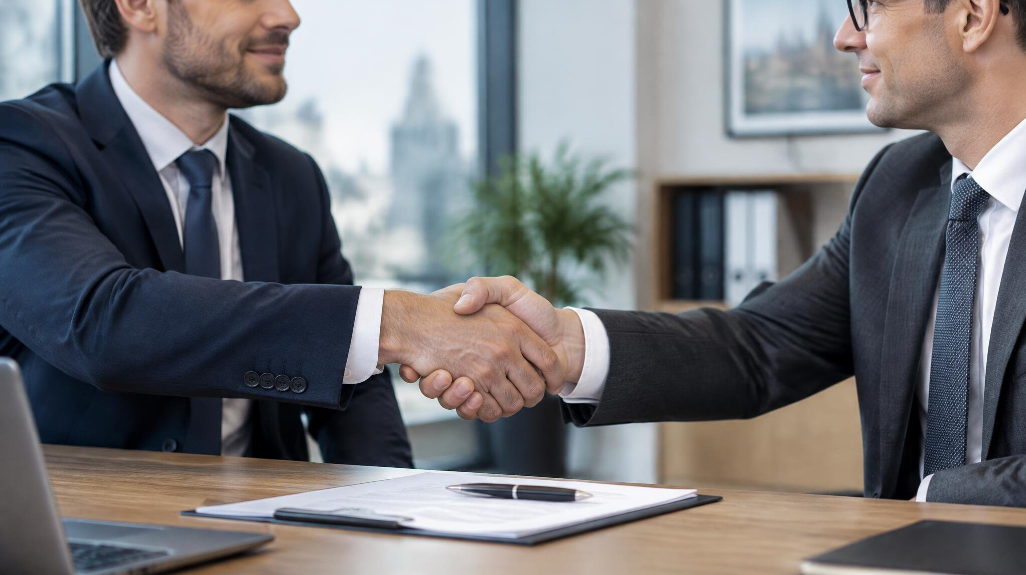 Two professionals shaking hands after an agreement